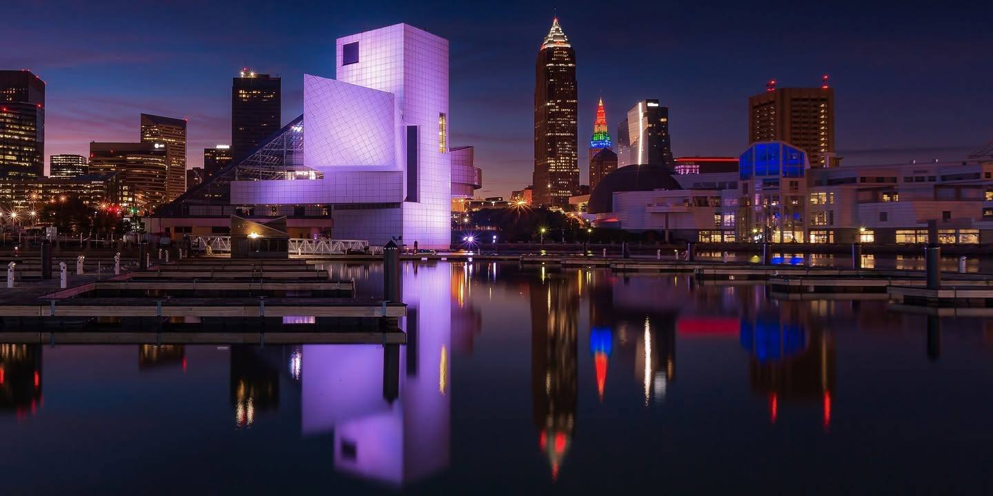 The Rock and Roll Hall of Fame and Cleveland skyline reflected at night